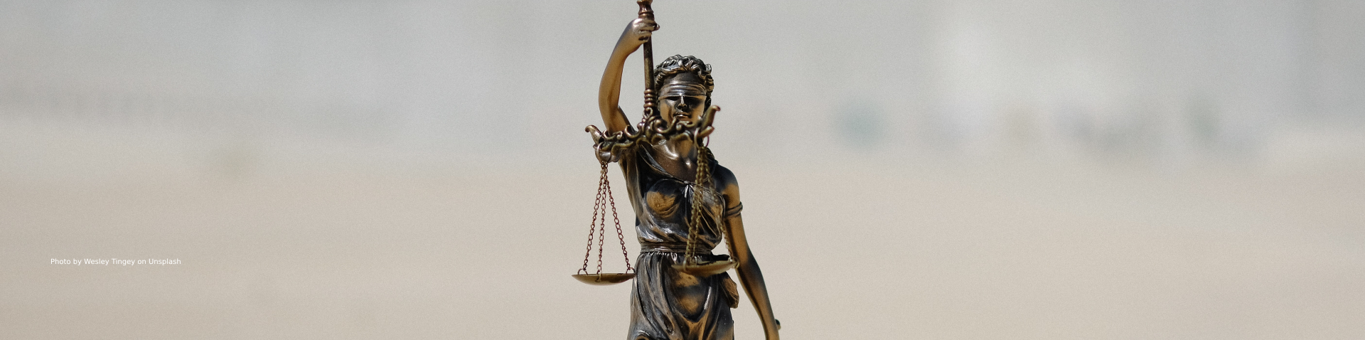Small figure of justice blindfolded holding a balance in her hands